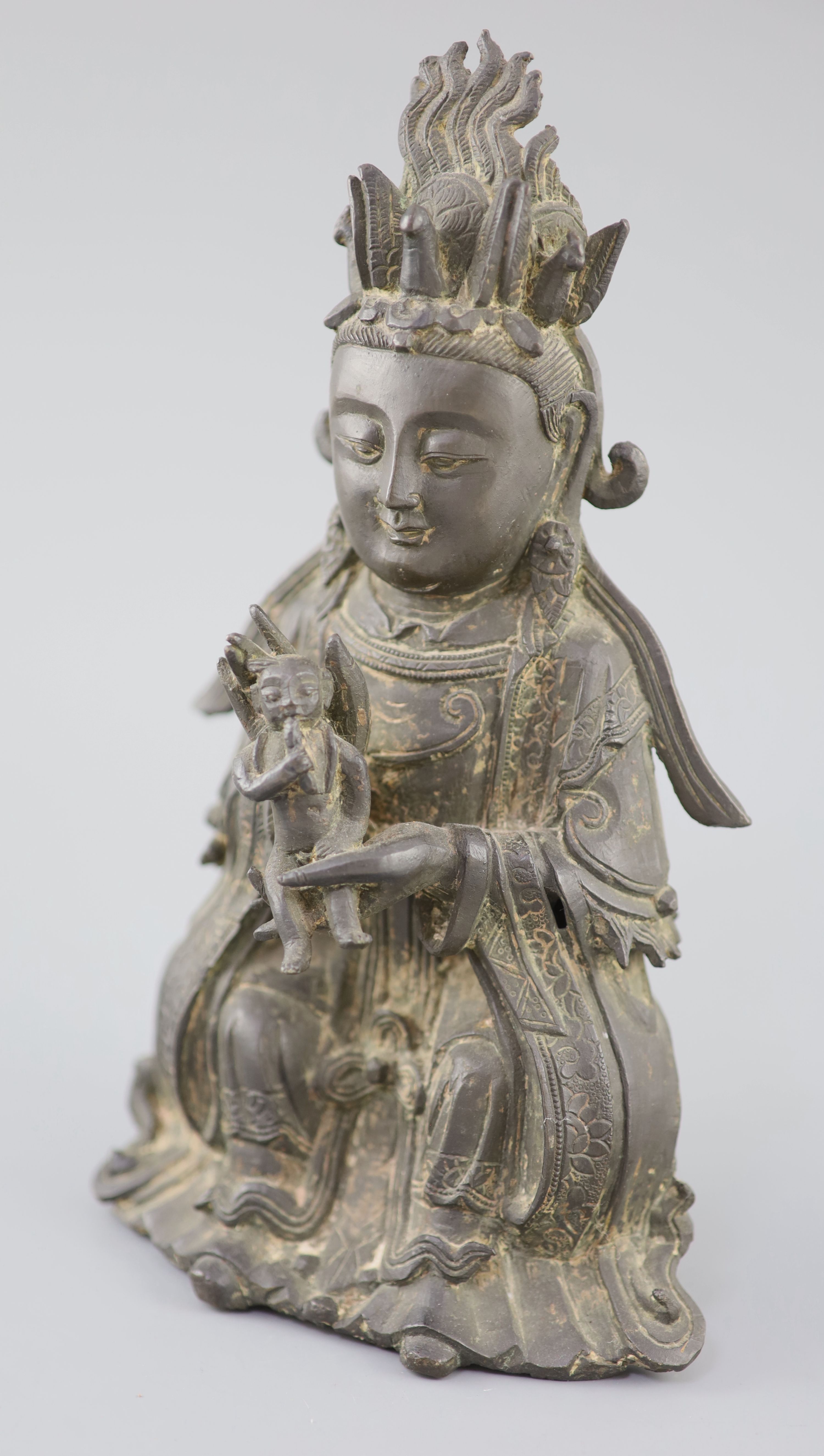 A Chinese bronze seated figure of Xi Wangmu, Queen Mother of the West, 15th/16th century, Ming Dynasty, 26.5cm high, small losses and l